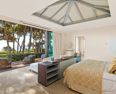 Master suite at Villa El Rincon in Marbella, offering unobstructed views of the gardens and the sea.