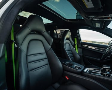 an Enlab Porsche car with a black leather interior and a green interior