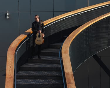 Classical Guitarist Filip Babic standing on stairs outside