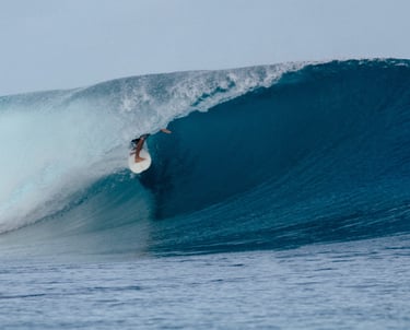 Surfer riding a perfect barrel wave in Mentawai, Indonesia — world-class surf destination.