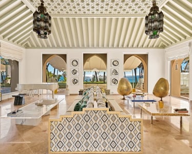 Living room at Villa El Rincon in Marbella featuring sea views, elegant décor, and floor-to-ceiling windows.