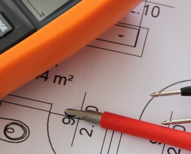 An electrical multimeter on top of building design drawings