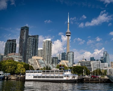 a boat on the water with a view of the toronto city