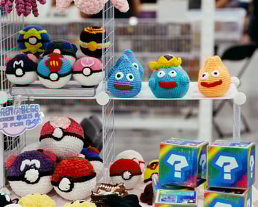 Crochet pokemon characters and poke-balls displayed for sale on shelves
