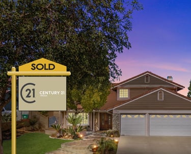 a sold sign in front of a house