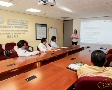 a group of people sitting at a table with a presentation