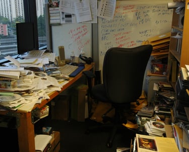 a desk with a computer monitor and a laptop
