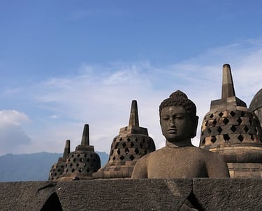 a buddha statue in front of a large buddha statue