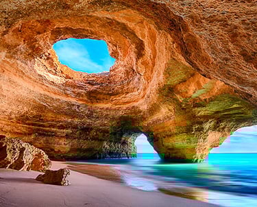 a cave in a cave with a view of the ocean