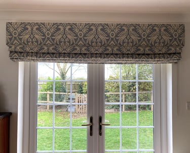 A large blind with a solid fabric in the same fabric which is carefully pattern matched