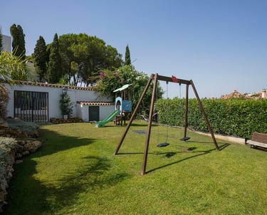 a swing set up in a garden with a swing set