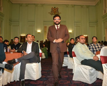 Speaker addressing an engaged audience at a formal event.