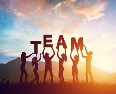 a group of people holding up a team building sign