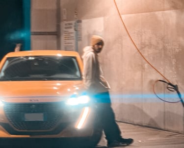 a man standing in front of a car with a light on it