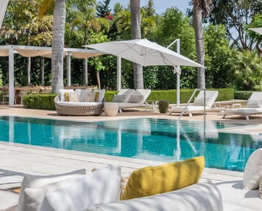 Villa Serenity poolside with daybeds and chic white pergola