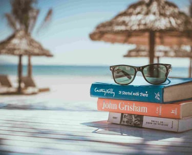 Sunglasses and books on a beach table