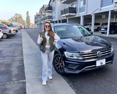 Girl standing in front of volkswagen Tiguan 2019 car