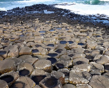 a large rock formation on the shore of a beach giants causeway