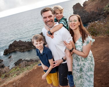 Family portrait on rocks at Lido Promenade Madeira with ocean cliffs by Mihail Zhelezniak