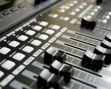 a close up of a sound mixer with a sound board
