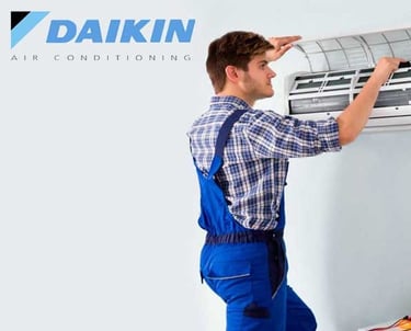 a man and woman standing in front of a wall mounted air conditioner