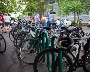 A full row of bikes on a long bike rack