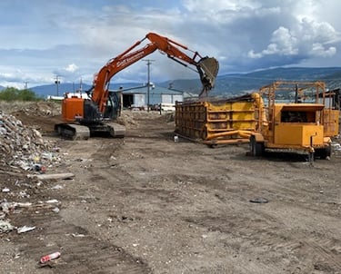 a construction site with an excavator and an incinerator
