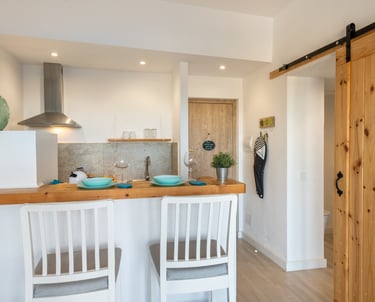 kitchen with American-style bar table and high wooden chairs
