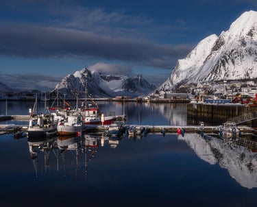 Sailboats in harbor infront of Fjords Lofoten Norway