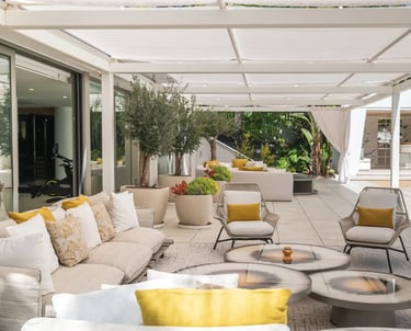 Shaded poolside sofas and lounge area at Villa Serenity Marbella