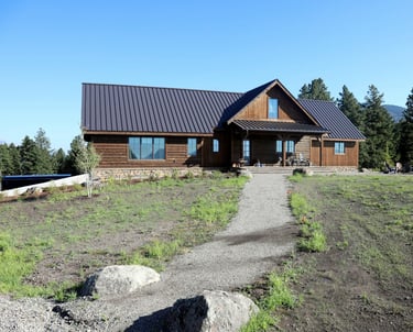 a house with a brown metal roof and a brown metal roof