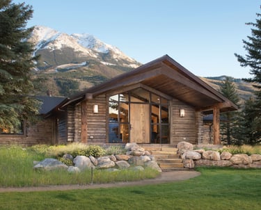a log cabin with a mountain view of a mountain