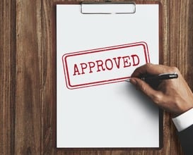 Paperwork with Approved stamped on it