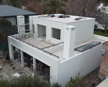 a house with a roof that has a balcony and a balcony