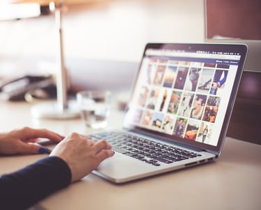 a person sitting at a desk with a laptop