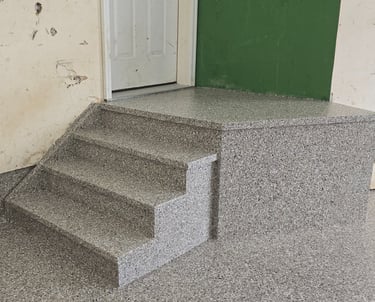 Flake garage floor coating on stairs with seamless cove base