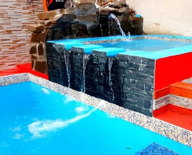 a pool with a waterfall and a waterfall