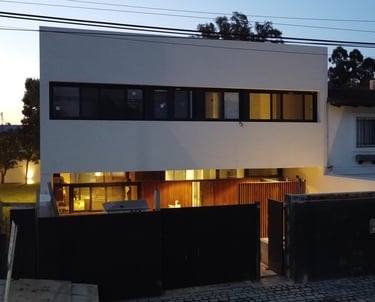 a house with a large window and a fenced in area