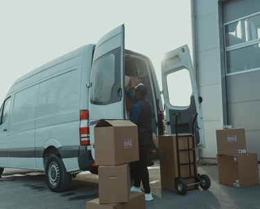 a man is moving boxes of boxes into a van