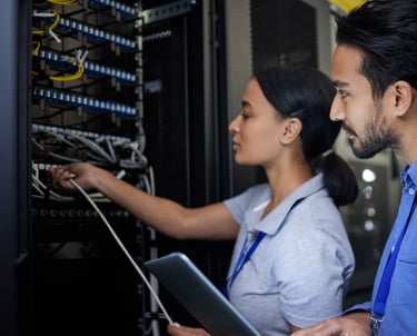 a man and woman in a server room