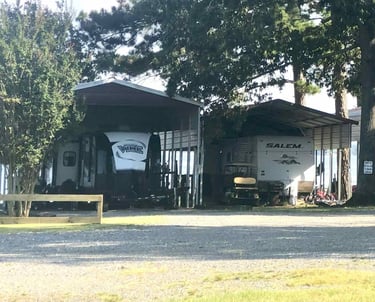 camper trailers under a metal canopy awning