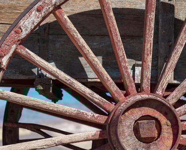 the red spokes of a wooden wagon wheel at harmony borax works in death valley
