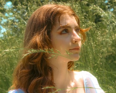 creative cinematic portrait of Virginia student in a park field in northern virginia