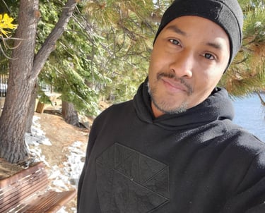 Picture of Wil with snow on the ground near lake tahoe with a black hoodie and beanie