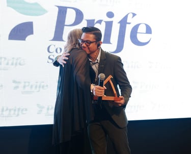 a man in a suit and tie is giving a hug