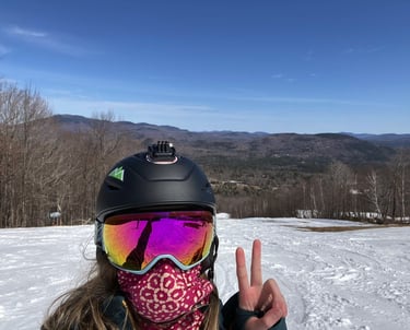 girl skiing giving peace sign