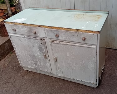 Dilapidated cupboard with peeling white paint