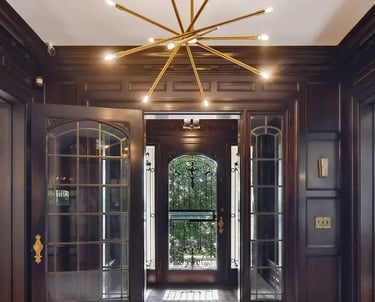 a large foyer with a chandelier and a chandelier