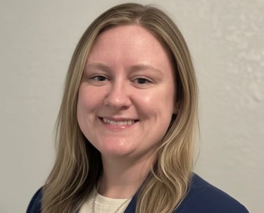 a woman in a blue jacket and white shirt
