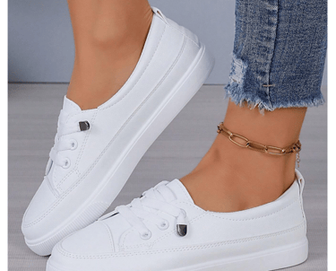 White lace-up fashion sneakers styled with maternity overalls.